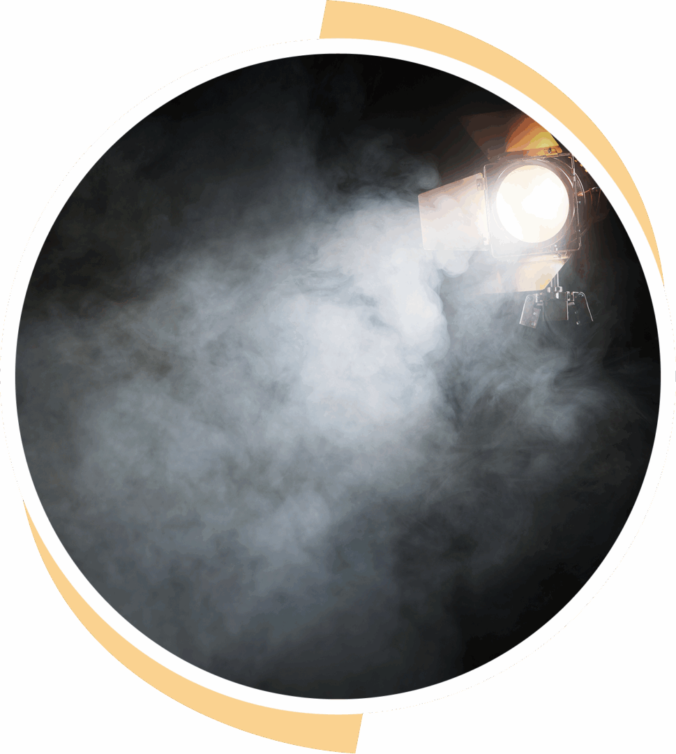 Bright spotlight shining through thick smoke or fog.