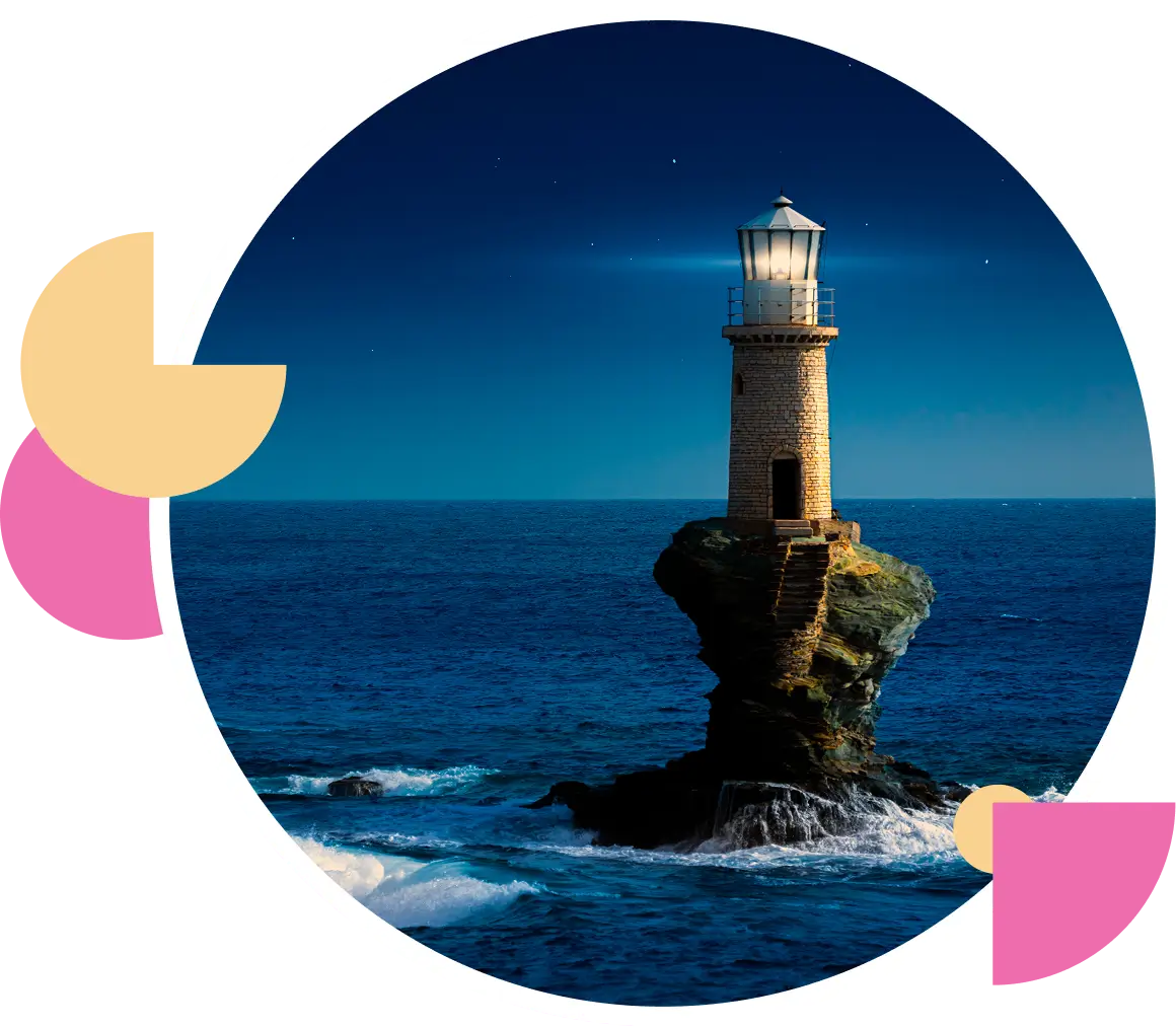 Lighthouse illuminating rocky coast at night.